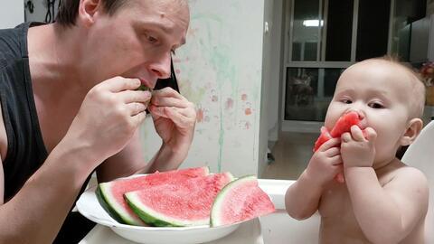 父亲带孩子吃瓜,温馨瞬间记录父亲带孩子共享夏日清凉